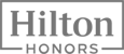 The image displays the "Hilton Honors" logo in gray with the word "Hilton" inside a rectangular border, and "HONORS" written below.