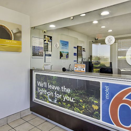 A reception area of Motel 6 with a sign that reads 