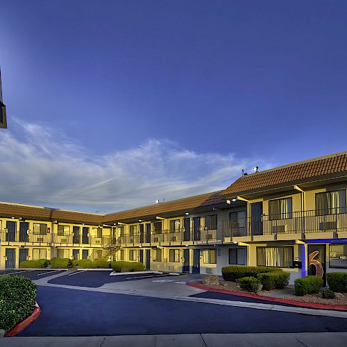 This image shows a two-story, L-shaped motel with a 